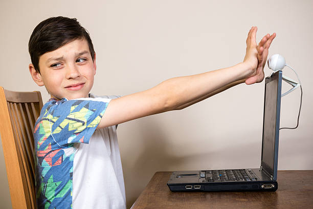 young boy blocking a webcam - online sex 個照片及圖片檔