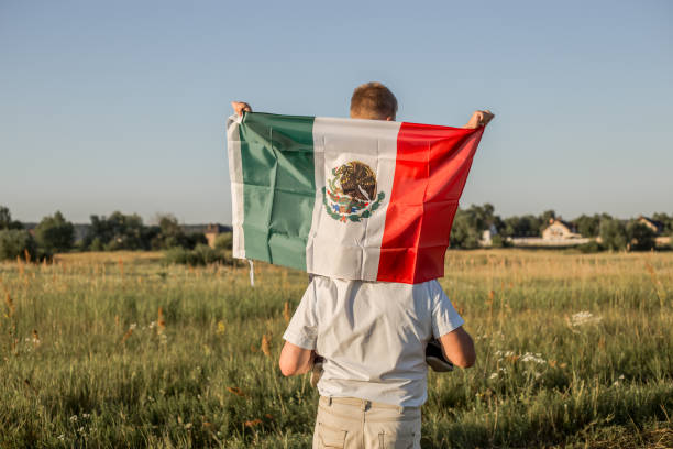 Young boy holding flag of Mexico. "September 16. Independence Day of Mexico. Mexican War of Independence, 1810." stock photo