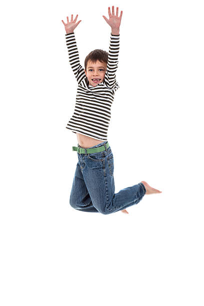 Young boy jumping really high on white background stock photo