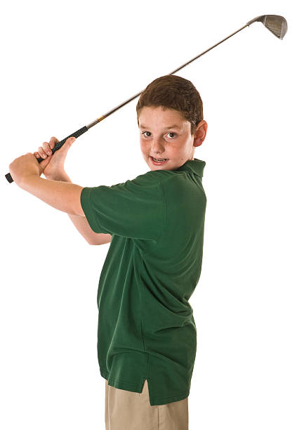 Young boy swinging a golf club stock photo