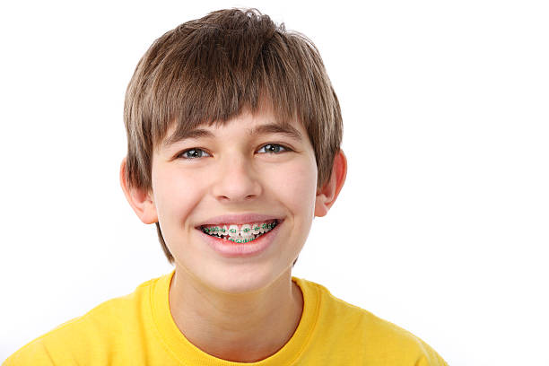 Young Boy With Braces  gchutka stock pictures, royalty-free photos & images