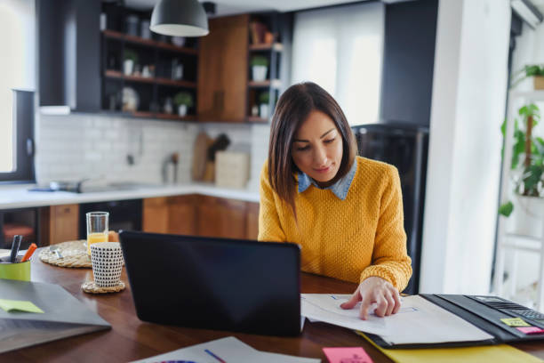 Young business entrepreneur woman working at home while having breakfast Young business entrepreneur woman working at home. Freelance woman programmer working from home working from home stock pictures, royalty-free photos & images