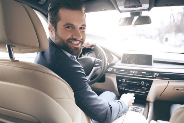 Young business man test drive new car Young business person test drive new vehicle happy man driving suit stock pictures, royalty-free photos & images