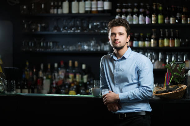 Young businessman at bar counter Young businessman at bar counter bar drink establishment photos stock pictures, royalty-free photos & images
