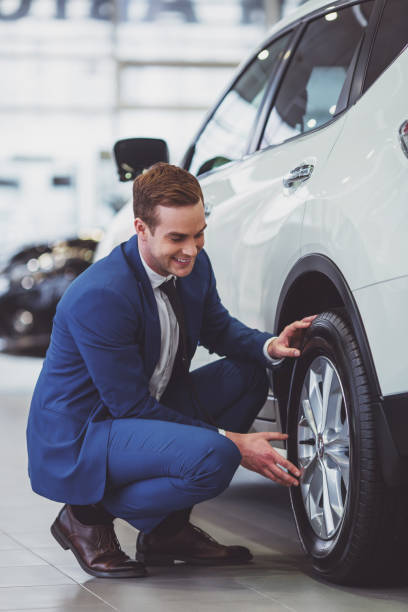 Young businessman in motor show stock photo