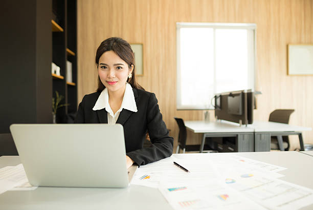 Young businesswoman sitting and smiling stock photo