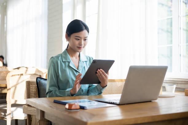 Young businesswomen working with Digital Tablet stock photo