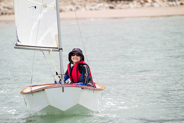 Young child sailing a small dinghy boat stock photo