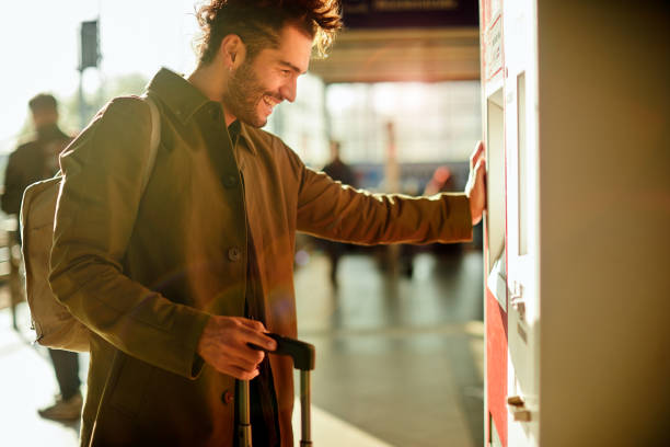 A young commuter buying tickets in a subway station. Lifestyle young man in the streets of Berlin.
Young traveler in Berlin's train station.
A young commuter buying tickets in a subway station. man trench coat stock pictures, royalty-free photos & images