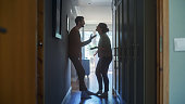 istock Young Couple Arguing and Fighting. Domestic Violence Scene of Emotional abuse, Stressed Woman and aggressive Man Having Almost Violent Argument in a Dark Claustrophobic Hallway of Apartment. 1339226387