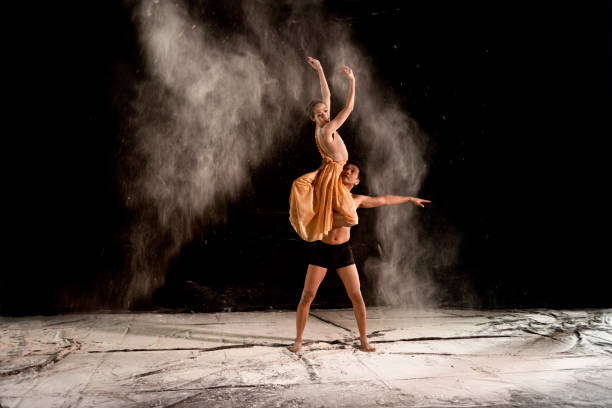 Young Couple Ballet Dancing With Powder In The Stage