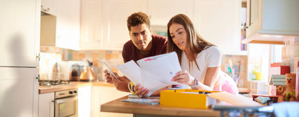 young couple chatting about home finances stock photo