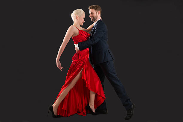 Young Couple Dancing On Black Background Stock Photo