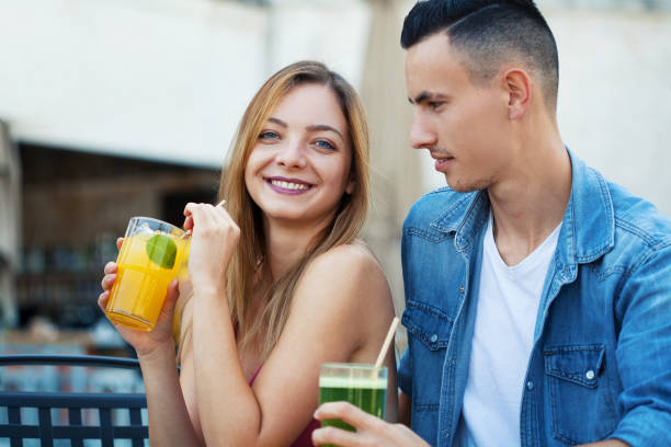 Young couple drinking fruit juices stock photo