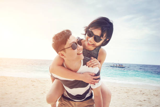 Young couple enjoying their summer vacation on beach stock photo