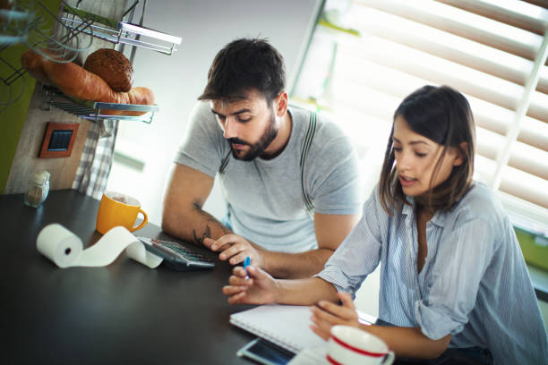 Young couple going through monthly expenses. stock photo