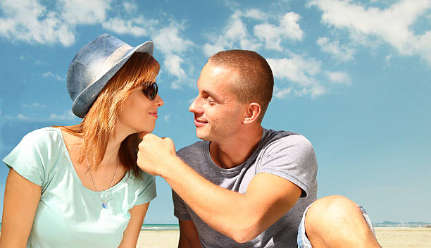 young couple in love on a sunny beach stock photo