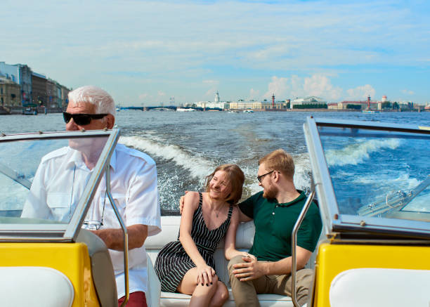 A young couple is traveling on a speedboat. stock photo