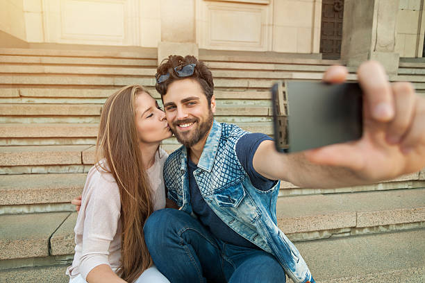 Young couple makes his selfie stock photo