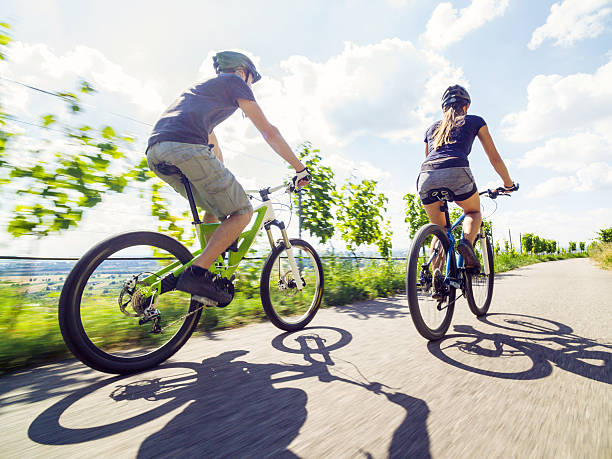Young couple riding their mountain bikes stock photo