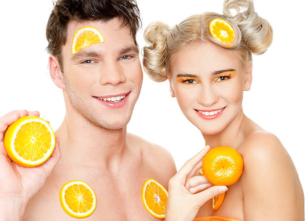 young couple with oranges stock photo