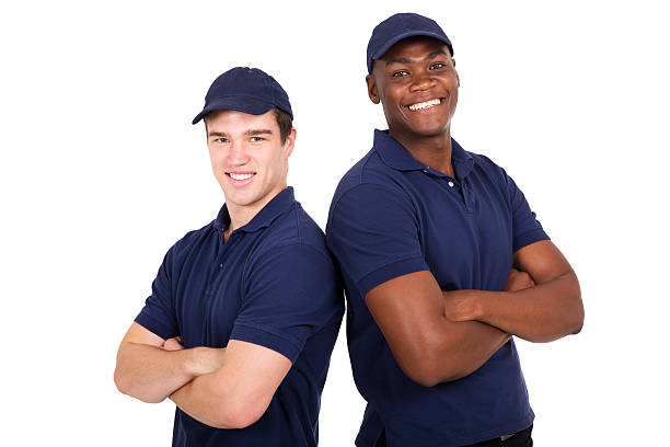 young co-workers with arms crossed portrait of happy young co-workers with arms crossed african american plumber stock pictures, royalty-free photos & images