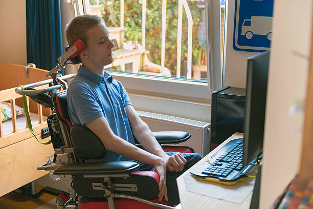 Young disabled man playing computer game stock photo