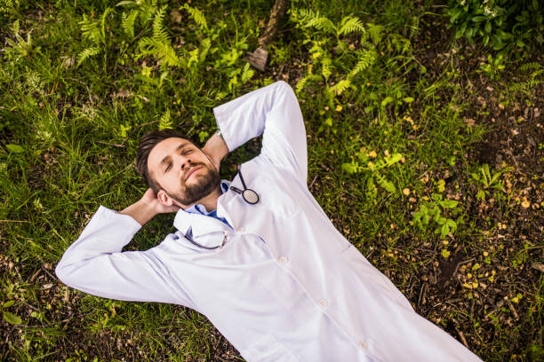 Young doctor sleeping in nature. stock photo