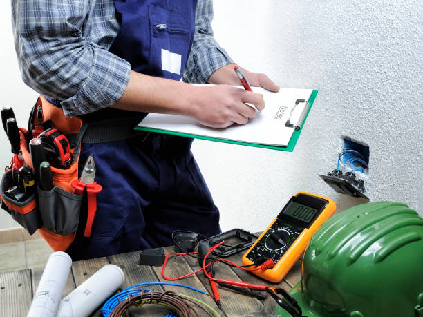 Young electrician working in a residential electrical installation Young electrician takes notes while working in a residential electrical installation electrical component photos stock pictures, royalty-free photos & images