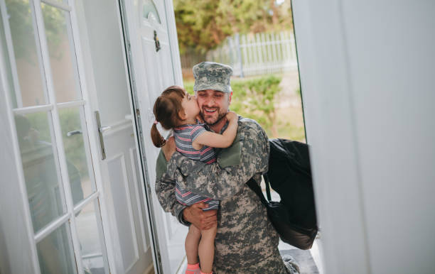 Young family welcoming military father returning home  soldiers returning home stock pictures, royalty-free photos & images