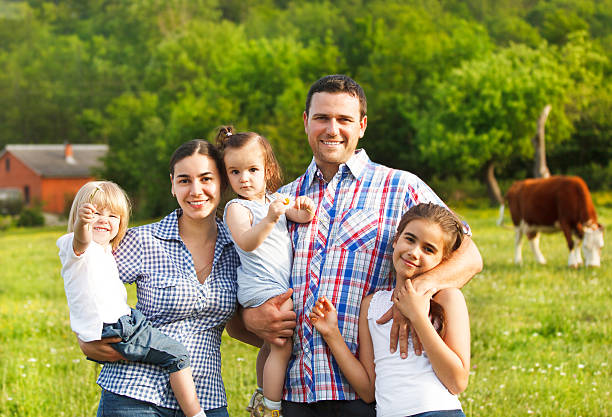 Young family with three children on the farm stock photo