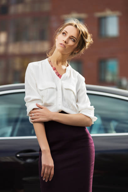 Young fashion woman in white shirt and pencil skirt stock photo