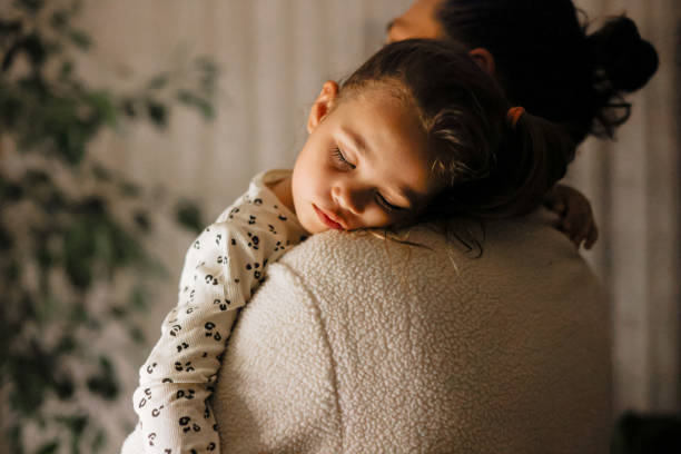 Young father and daughter taking a nap together stock photo