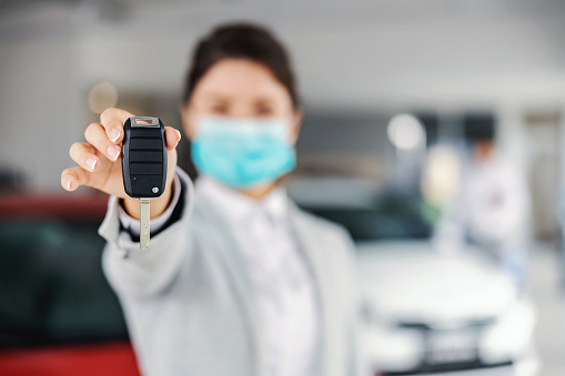 https://media.istockphoto.com/photos/young-female-car-seller-with-face-mask-standing-in-car-salon-and-car-picture-id1295952838?b=1&k=20&m=1295952838&s=170667a&w=0&h=FMcMwYYCWFdTRmmIJSKWyLhunVEp611CHG9OZwsTTHw=