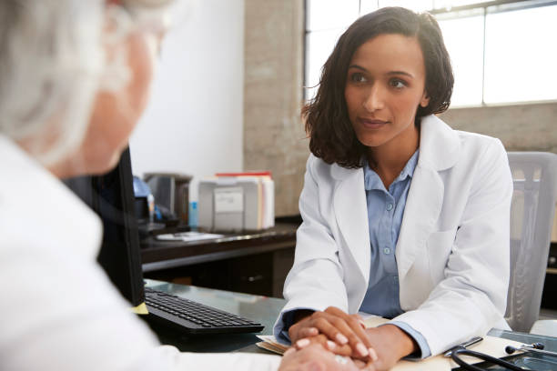 Young female doctor in consultation with senior patient Young female doctor in consultation with senior patient mental health professional photos stock pictures, royalty-free photos & images