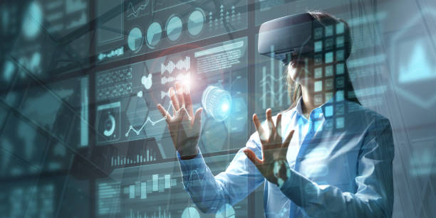 Young female engineer wearing vr headset touching HUD screen stock photo