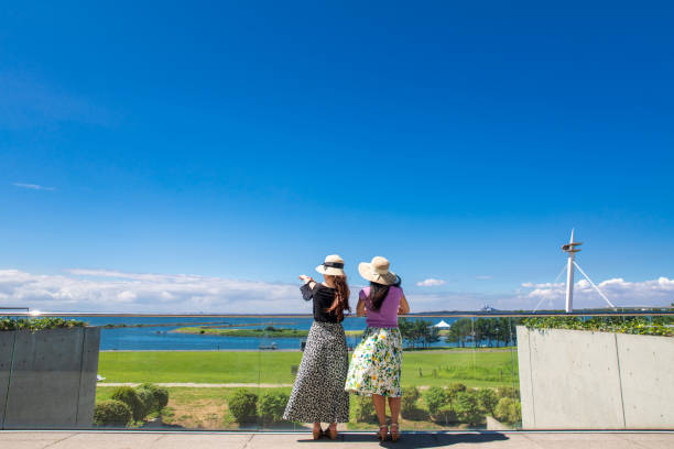 Young female friends looking at view in summer Young female friends looking at view in summer japan  tourism stock pictures, royalty-free photos & images