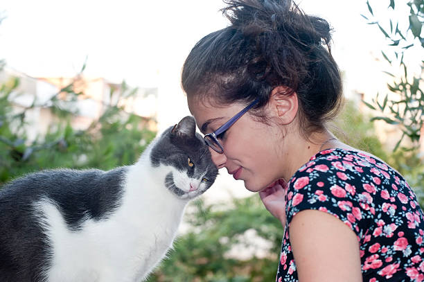Young female holding her loving cat stock photo