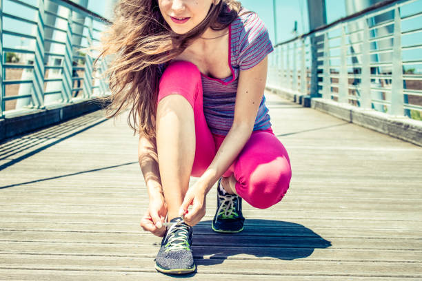 young female jogger ready to run stock photo