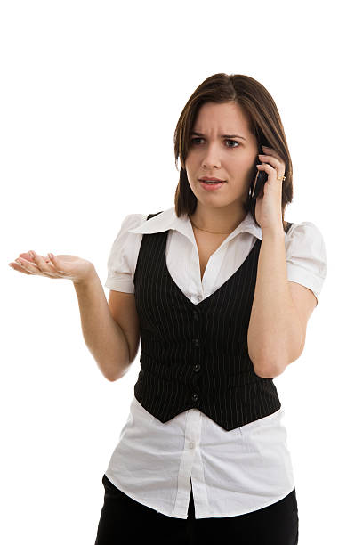 Young female on cellphone gesturing and making a concerned face stock photo