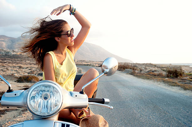 Young female on motorcycle trip stock photo