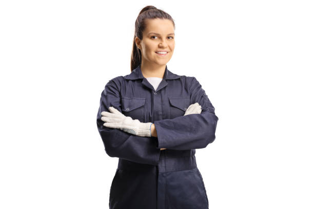 Young female worker in an overall uniform and gloves posing stock photo