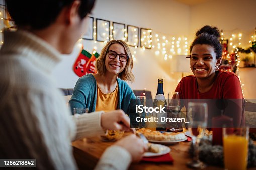 istock Young friends at home during Christmas and New Year's night 1286218842