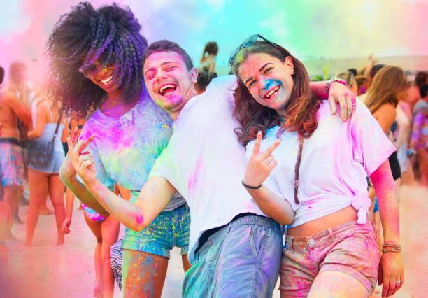 young friends having fun at holi festival of color. stock photo