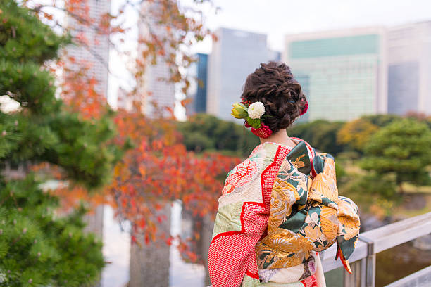 Young Furisode girl in autumn garden Young Furisode girl in autumn garden furisode stock pictures, royalty-free photos & images
