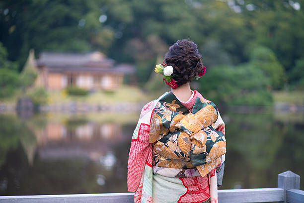 Young Furisode girl in Japanese garden Young Furisode girl in Japanese garden furisode stock pictures, royalty-free photos & images