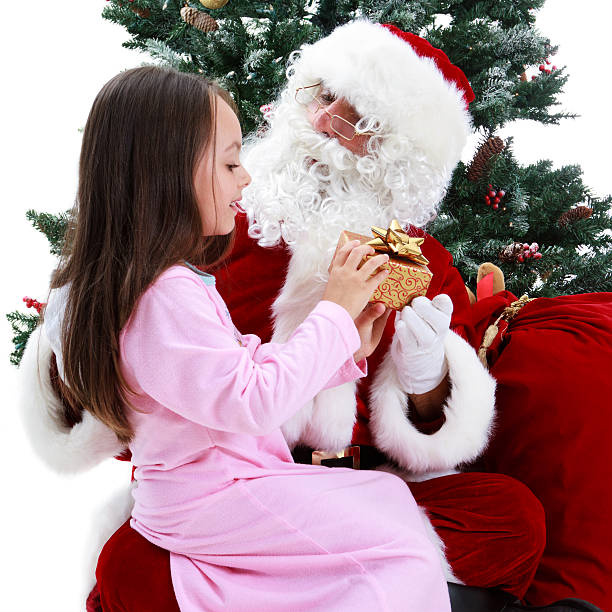 Young Girl and Santa Under Christmas tree stock photo