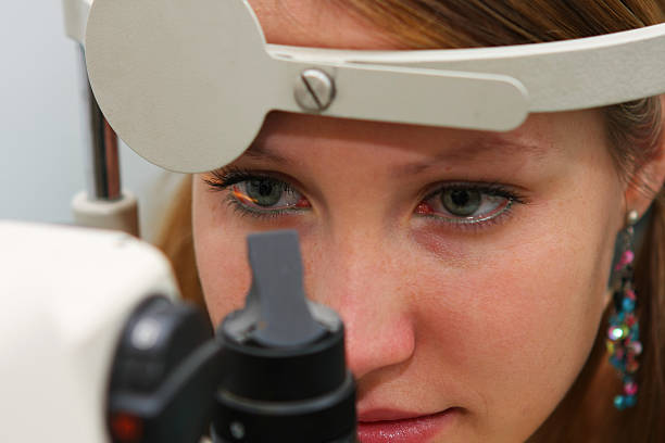 Young girl at the optometrist checking her vision stock photo