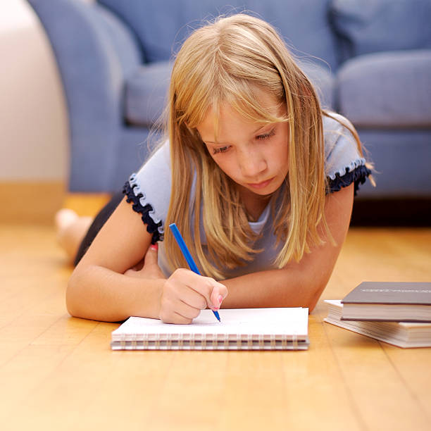 Young girl doing homework stock photo