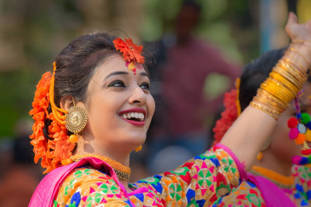 Young girl in spring festive make up. KOLKATA , INDIA - MARCH 12, 2017: Beautiful young girl with spring festive make up with flowers , joyful expression at Holi/Spring festival,known as Dol (in Bengali) or Holi (in Hindi) celebrating arrival of Spring. holi photos stock pictures, royalty-free photos & images
